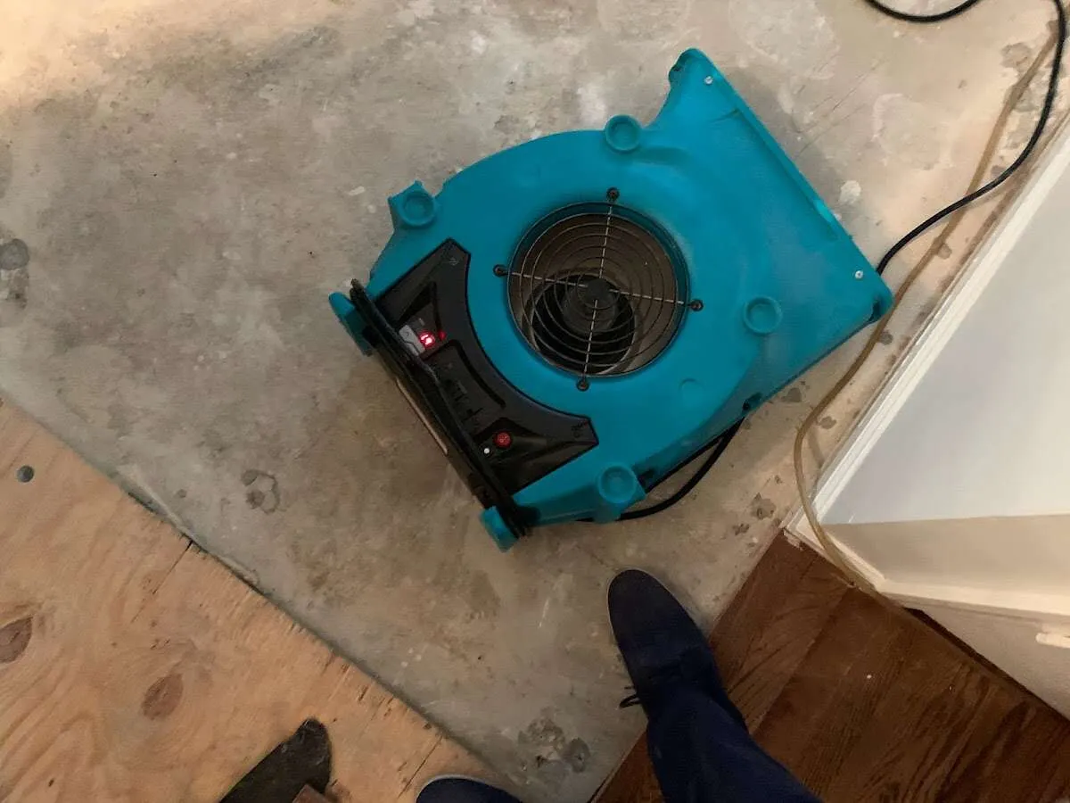 Air mover drying subfloor during Leak Detection & Repair in Oronoko